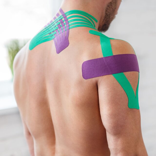 Mann mit kinesiologischen Tapes an der Schulter